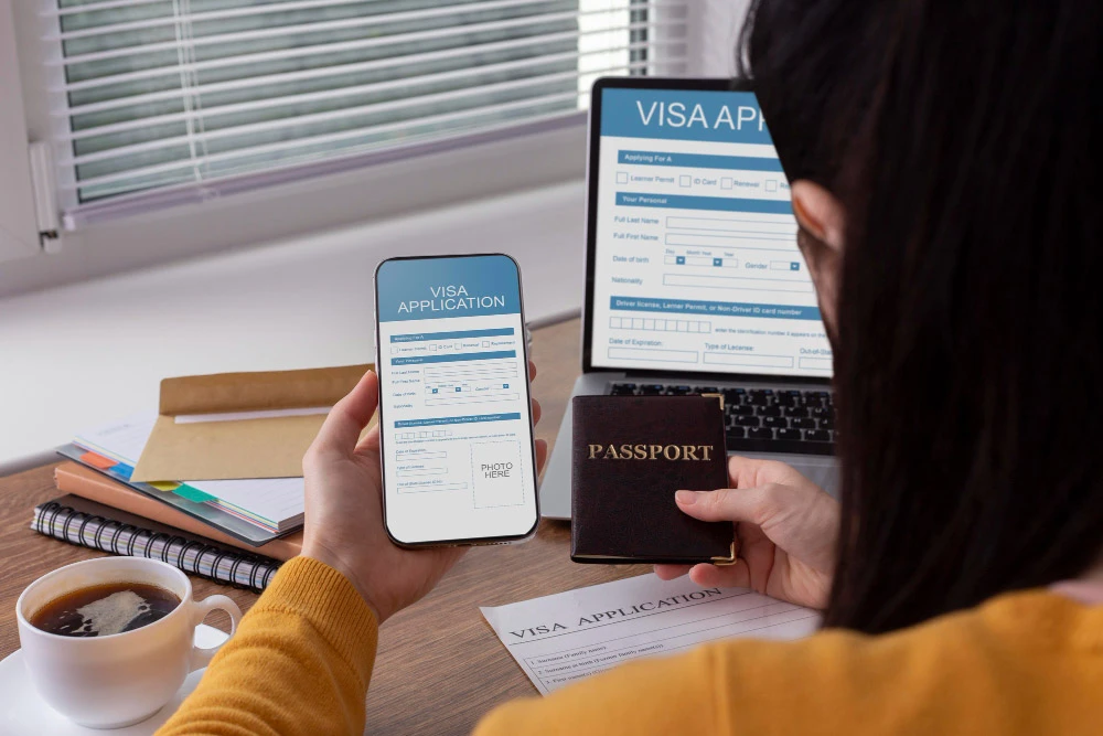 Woman holding passport and phone showing visa application