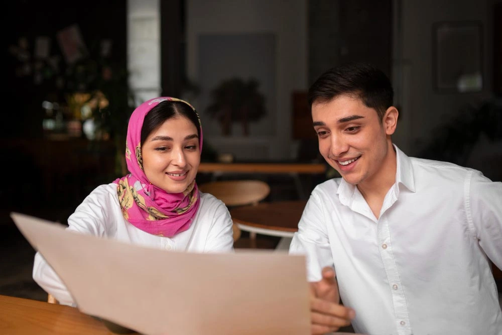 Two colleagues reviewing document together