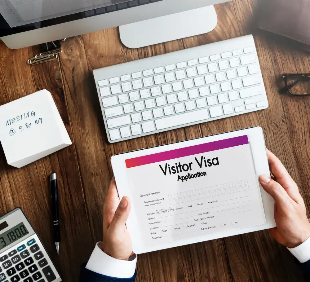 Professional completing visitor visa application form on tablet